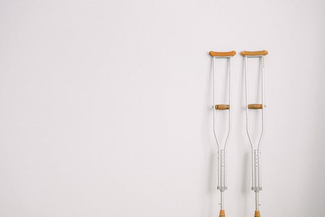 set of crutches leaning on white wall